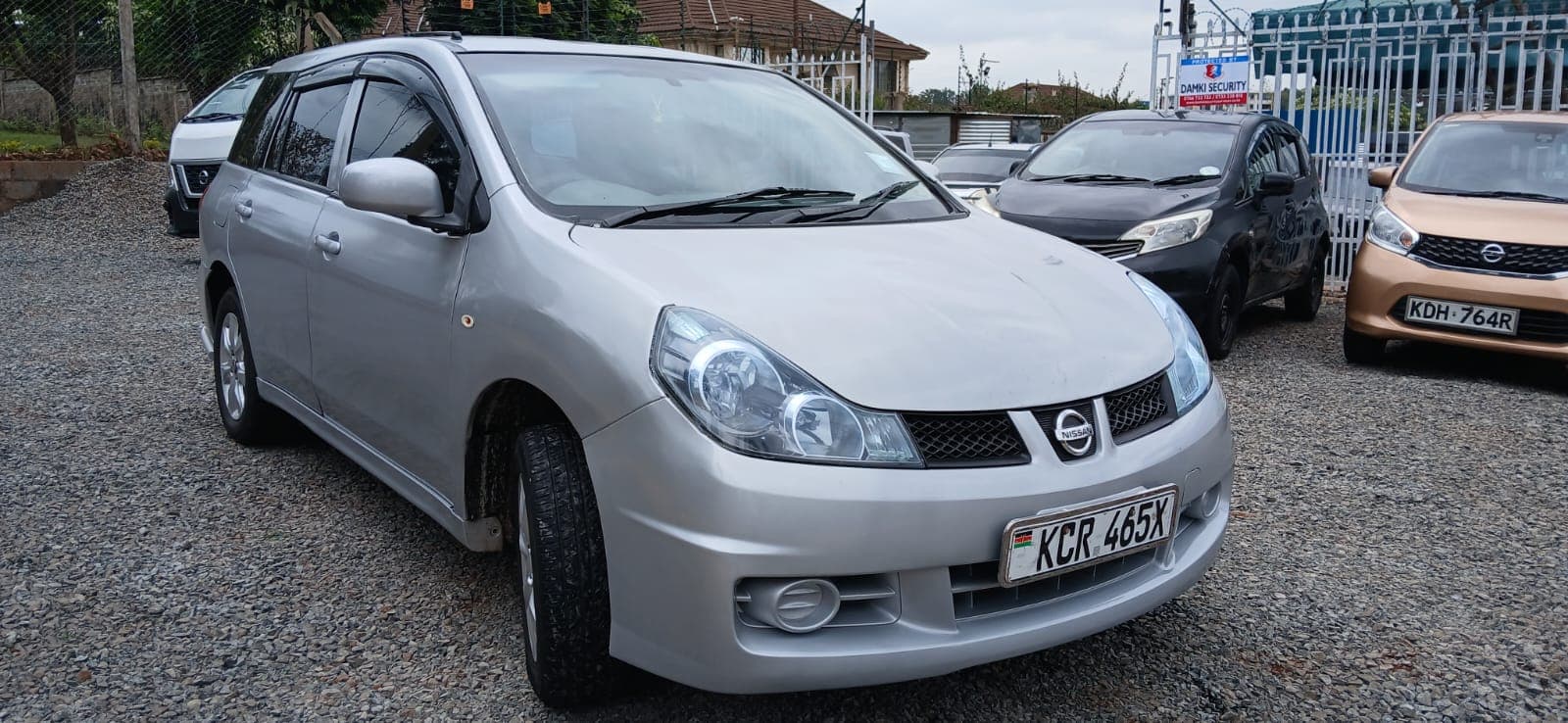 Red Mazda Demio hatchback